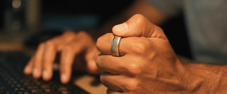A developer presses Interface with his thumb beside a keyboard, in a frame from the teaser